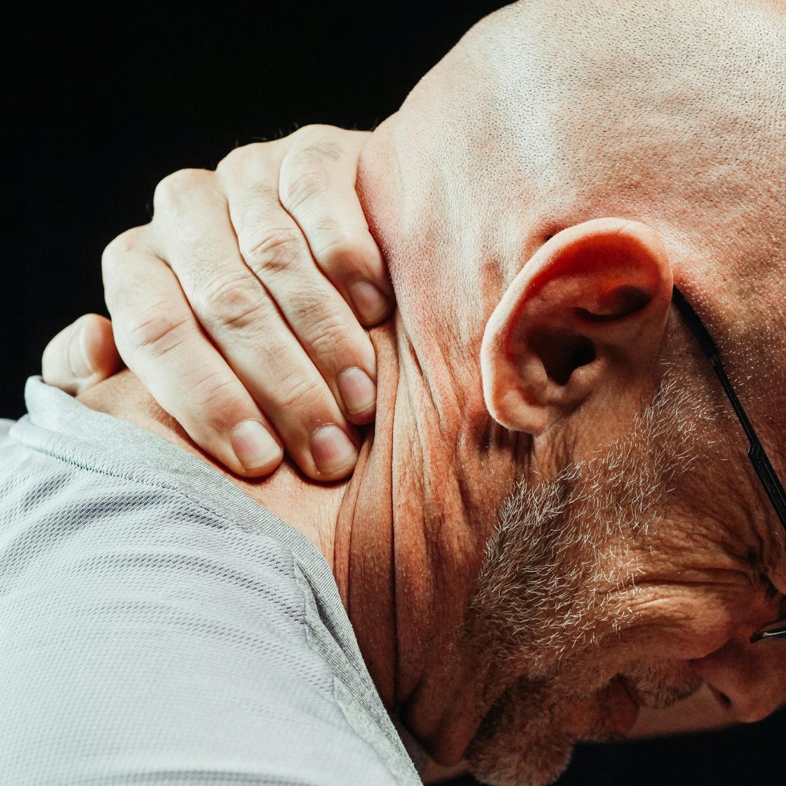 Close-Up Photo of a Man Having a Neck Pain